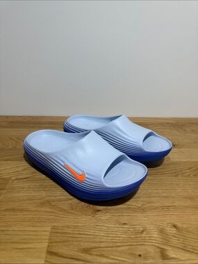 Brand new men’s size 9 Nike Rejuven8 Light Blue Slide Sandals with Orange Swoosh